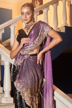 Purple polyester pre-draped saree with sequins embroidery. Comes with a black padded blouse.
Components: 2
Pattern: Embroidered
Type Of Work: Sequins
Neckline: V Neck
Sleeve Type: Sleeveless
Fabric: Polyester
Color: Purple
Other Details: 
Attached lining
Product Weight: 500 gms
Occasion: Wedding - Aza Fashions Draped Saree, Purple Saree, Padded Blouse, Drape Saree, Blouse For Women, Sequins Embroidery, Saree With Blouse, Blouse Online, Sarees Online