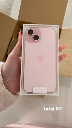 a person holding an iphone case in their hand with the box open and it's pink