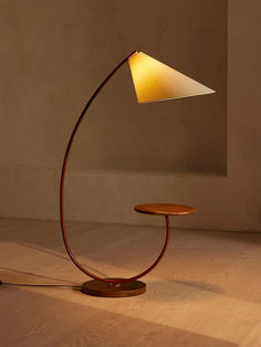 a lamp that is sitting on top of a wooden table in the middle of a room