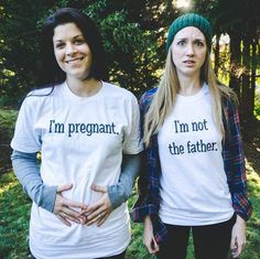 two women wearing t - shirts that say i'm pregnant, i'm not the father