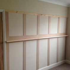 an empty room with white paneling on the wall and carpeted floor in front of it