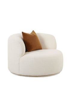 a white chair with brown pillows on it