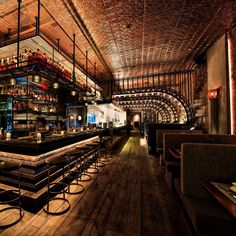 a dimly lit bar with lots of stools