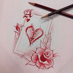 two pencils are next to a drawing of hearts and roses