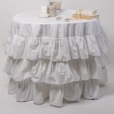 a white table topped with two books and a candle