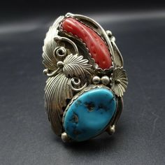 "VINTAGE NAVAJO RING DESCRIPTION: This spectacular ring features Sleeping Beauty turquoise and old red Mediterranean branch coral. The gemstones are secure in scalloped bezel, on a foundation of heavy gauge vintage sterling silver. Highly detailed applied leaves enhance the face of the ring. This impressive ring will be a treasured addition to your collection of fine vintage Native American jewelry. MEASUREMENTS: Ring face measures 2\" x 1 1/4\" Turquoise cabochon measures 20mm x 13mm RING SIZE: Southwestern Style Red Ring Jewelry, Vintage Coral Jewelry For Anniversary, Coral Vintage Jewelry For Anniversary, Vintage Red Oval Ring, Vintage Red Oval Rings, Unique Red Multi-stone Turquoise Ring, Handmade Southwestern Red Ring, Vintage Multi-stone Collectible Rings, Vintage Red Gemstone Jewelry