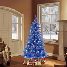 a blue christmas tree in a living room