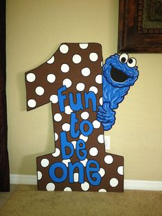 the sesame street number one sign is decorated with polka dots