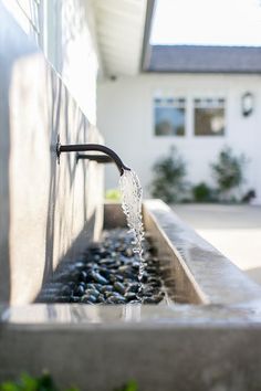 the water is running out of the faucet in the house's front yard