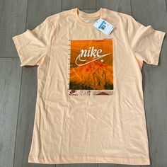 Brand New With Tags. Peach Nike Men’s Graphic Tshirt. Size Medium. Nike Summer Graphic Tee T-shirt, Nike Summer Graphic Tee, Nike Summer Graphic Print Shirt, Nike Graphic Print Shirt For Summer, Summer Nike Graphic Print Shirt, Nike Graphic Print Shirt, Nike Crew Neck Shirt With Graphic Print, Nike Short Sleeve Graphic Tee Shirt, Nike Summer Crew Neck Shirt