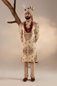 Frosted Almond Sherwani Set | Jatin Malik Introducing our masterpiece: the golden placement hand-embroidered sherwani. This exquisite sherwani showcases an intricate embroidery technique that utilizes various types of dabka and moti, creating a stunning visual impact. Paired with a wine hand-embroidered stole and matching safa, this ensemble epitomizes refined luxury and traditional excellence. Perfect for making a grand and elegant statement, this sherwani set is a testament to exceptional craftsmanship and timeless style. Included in purchase: Sherwani, Kurta, Churidar, Stole, Safa Product Specification Color: Golden Fabric: Linen silk Occasion: Engagement, Wedding, Bridal, Reception Style: Sherwani, Kurta, Churidar, Stole, Safa Care: Dry Clean Work: Hand Embroidery Customization options Semi-stitched Gold Kurta With Naqshi, Gold Churidar With Straight Kurta For Reception, Gold Straight Kurta Churidar For Reception, Designer Gold Sets With Naqshi Detailing, Gold Sherwani With Zari Work For Designer Wear, Festive Sherwani With Gold Embroidery For Festivals, Designer Wear Gold Sherwani With Resham Embroidery, Designer Gold Embroidered Sherwani, Designer Gold Sherwani With Resham Embroidery