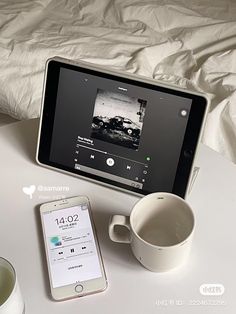 an ipad and cup on a table next to each other with the same device in front of them