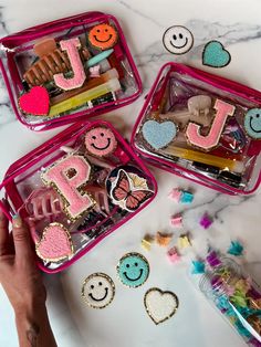 three pink plastic containers filled with cookies and candies