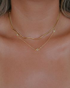 Add a touch of glow to your neck with the Ariela Necklace. Glowing cubic zirconia bezel set stones are spaced out onto a dainty chain creating a classic look that is so lightweight, you'll forget it's there. This is a must have for your necklace collection. THE DETAILS: 18k gold plated brass chain with cubic zirconia stones Length: 14.5 inches + 2" extension chain Custom Sizing Available -- If you would like your necklace shorter or longer, please leave a note at checkout or send an email to hel Gold Necklace Stack, Necklace Stack, Necklace Collection, Dainty Chain, Trendy Necklaces, Gold Piece, Brass Chain, Gold Jewellery, Gold Plated Jewelry