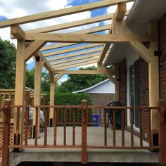 a wooden porch with an attached pergolan