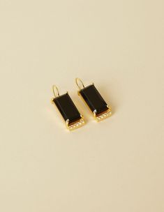 BEHIND THE DESIGN This classic light-weight earrings design showcases a stunning rectangular cut of a Black Onyx gemstone with a prong setting and a minimalist row of Cubic Zirconia. Designed to wear from day to night! DETAILS Metals: 18ct Gold Plated: a thick layer of 18ct Gold over brass. Nickel-free. Stone: Natural onyx gemstones and cubic zirconia Length: 3 cm / 1.1 inches Weight: 4.5 grams Sold as a pair. This piece contains natural gemstones which may vary slightly in colour and markings f Pearl Gemstone, Light Weight Earrings, Silver Rose Gold, Silver Roses, Showcase Design, Black Onyx, Designer Earrings, Ring Bracelet, Ring Necklace