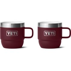 two red yeti mugs sitting next to each other on a white background with the words yeti in silver lettering