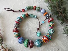 One of a kind, perfect choice for you, because you are unique too.  Each bead of this beautiful  necklace is unique and hand painted with much love and patience. Colorful wooden beads with many different abstract pattern in red, emerald green, orange, white, blue, black... The beads are strung on a strip of genuine leather. The paints are acrylic, protected by a transparent varnish. The necklace is fastened with a beads and a noose.  Rustic statement ethnic bohemian fashion necklace.  This amazi Wooden Jewellery, Wooden Bead Necklaces, Jewelry Boho, Bohemian Fashion, Wardrobe Style, Beautiful Necklace, Wooden Jewelry, Beads Necklace, Necklace Handmade