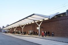 a group of people standing outside of a train station