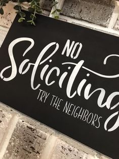 a sign that says no solicing try the neighbor's handwritten lettering