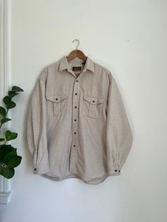 "Cream toned 100% cotton Eddie Bauer button down shacket. A soft, earthy piece perfect for layering.  Measures: labeled L (men's) - 23\" pit to pit - 30\" length Good vintage condition. Slight wear on chest pocket, but no damage or signs of wear inconsistent with age. Please view all pictures before purchasing." Winter Cotton Shacket In Solid Color, Vintage Relaxed Fit Button-up Shacket, Long Sleeve Cotton Shacket With Buttons, Cotton Long Sleeve Shacket With Buttons, Rugged Cotton Button-up Outerwear, Beige Relaxed Fit Shacket With Button Closure, Beige Cotton Shacket With Buttoned Pockets, Everyday Cotton Single Breasted Shacket, Everyday Cotton Single-breasted Shacket