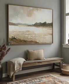 a painting hanging on the wall next to a wooden bench in front of a window