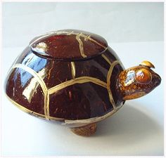 a ceramic turtle is sitting on top of a table