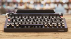 an old fashioned typewriter sitting on top of a wooden table