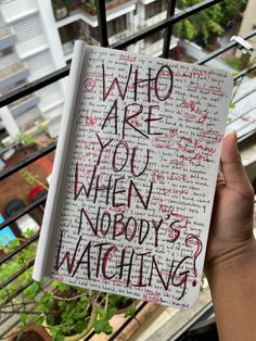 someone holding up a notebook with writing on it that says who are you when nobody's watching?