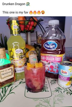 a table topped with lots of different types of drinks next to bottles and cans of liquid