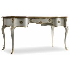 an antique white and gold desk with drawers