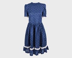 "A super cute vintage womens dress from the late 70s / early 80s. In a navy blue, sheer polycotton fabric with a gathered skirt and slightly loose waist which gives such a current feel. It has pretty puffed sleeves and a cute dove print throughout.  Size: Unlabelled; fits roughly like a modern womens UK 10/ US 6 but this gives the intended loose fit at the waist.  Bust - 34\" / 86cm Waist - 30\" / 76cm Hips - Free Length (Shoulder to Hem) - 39\" / 99cm Shoulder to Shoulder - 14\" / 35cm Sleeve P Vintage Blue A-line Midi Dress, Blue Vintage A-line Midi Dress, 1950s Style Blue Summer Dress, Retro Blue Cotton Dresses, Blue Retro Cotton Dresses, Vintage Blue Cotton Mini Dress, 1950s Blue Summer Dress, Blue Knee-length Vintage Dress For Vintage Fashion, Blue 1950s Style Summer Dress