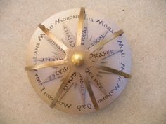 a spinning wheel with words written on it and a gold ball in the middle is shown