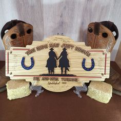 a wooden sign with two cowboy boots on it