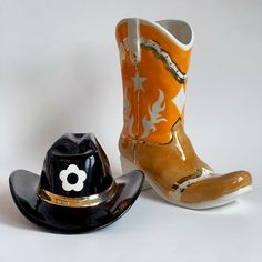 two cowboy boots and a hat on a white background