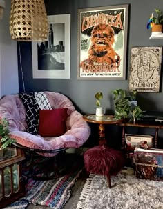 a living room filled with lots of furniture and pictures on the wall next to a window