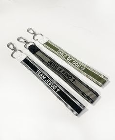 three lanyards with black and white designs on them sitting next to each other