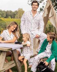 Wear your love of nature on your sleeve. Outdoor adventure meets cozy comfort with our new print featuring illustrations of classic camping scenes. Lush pine trees, pitch-perfect tents, glowing lanterns, and blazing bonfires against the backdrop of nature capture the essence of cherished family memories made around a campfire. This classic pajama set is accented with green piping and finished with pearl buttons. The fabric is made from 100% of the finest quality cotton. It is yarn-dyed to preven Holiday Pajamas Family, Kids Pajama Party, Couples Pajamas Matching, Portland Christmas, Italian Royalty, Santa Sessions, Family Christmas Pjs, Family Matching Christmas Pajamas, Christmas Family Pajamas