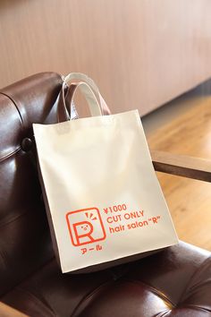 a bag sitting on top of a brown chair