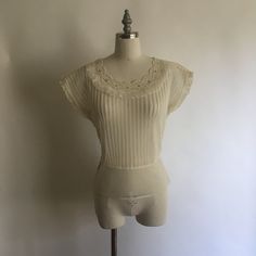 "Gorgeous sheer 1940's short sleeve nylon blouse with lace collar and rhinestones has pretty cap sleeves with a layer of pleated ruffle. Blouse zips up on the side and is in excellent vintage condition. Made by Debcraft and possibly one of the nicest nylon blouses I have come across! Shoulders 15\" Chest up to 36\" Waist 28\" Length from back of neck to hem 18\" Vintage garments have been previously worn and lovingly cared for, they may however have a blemish or two. Here at MadelonVintage, I tr Fitted Sheer Lace Top With Short Sleeves, Sheer Lace Short Sleeve Top, Elegant Sheer Lace Top With Short Sleeves, Elegant Sheer Short Sleeve Lace Top, Stretch Lace Trim Short Sleeve Blouse, Stretch Lace Top With Short Sleeves, Short Sleeve Lace Top For Daywear, Fitted Vintage White Top, Fitted Lace Collar Top With Short Sleeves