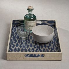 a bowl and bottle sitting on a tray