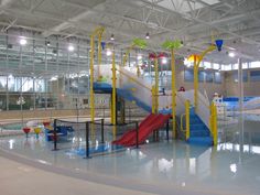 a large indoor swimming pool with a slide