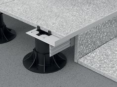 two black and white pedestals on top of a gray floor next to each other