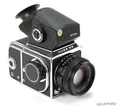 an old fashioned camera with a lens attached to it's body and flash drive