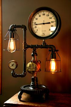 an old fashioned steam clock on top of a table with two light bulbs attached to it