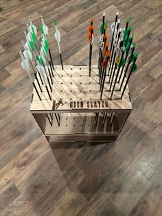 a display case with several different types of arrows in it on a wooden floor that says deep sky