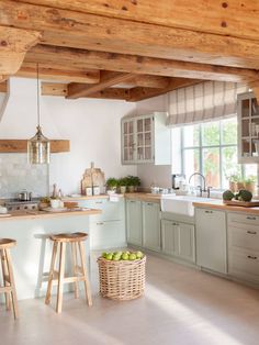 a kitchen filled with lots of counter top space and wooden stools next to a sink