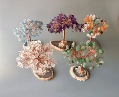 four miniature trees are sitting on top of each other