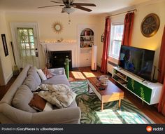 a living room filled with furniture and a flat screen tv