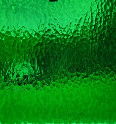 a close up view of a green glass window